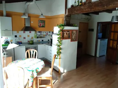 a kitchen with a table and a white refrigerator at Centro con encanto. in Valencia