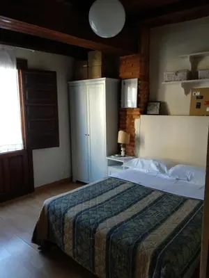 a bedroom with a bed and a cabinet in it at Centro con encanto. in Valencia