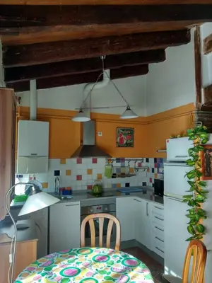 a kitchen with white appliances and a table and chairs at Centro con encanto. in Valencia