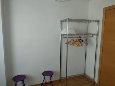 a walk in closet with two stools and a shelf at Apartamento en la Ciudad de las Artes y las Ciencias in Valencia