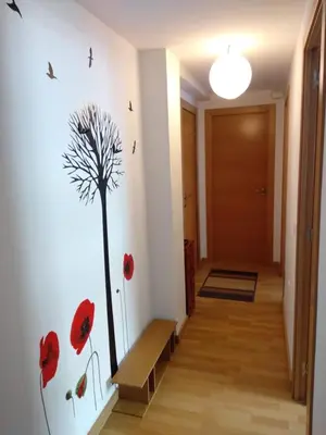 a hallway with red poppies on the wall at Apartamento en la Ciudad de las Artes y las Ciencias in Valencia