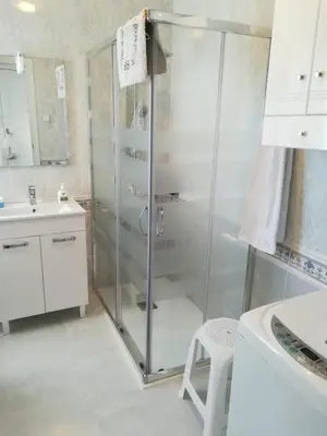 a bathroom with a glass shower and a sink at apartamento junto al mar in Cullera