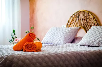 a teddy bear sitting on top of a bed at Casa En La Playa Del Rey in Mareny Barraquetas