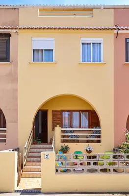 a house with an archway in front of it at Casa En La Playa Del Rey in Mareny Barraquetas