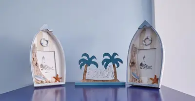a table with three display cases with palm trees at Casa En La Playa Del Rey in Mareny Barraquetas