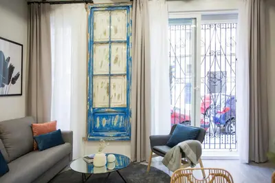 a living room with a couch and chairs and a window at Buenos Aires Apartments in Valencia