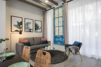 a living room with a couch and a table at Buenos Aires Apartments in Valencia