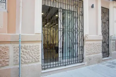 a black gate on the side of a building at Buenos Aires Apartments in Valencia