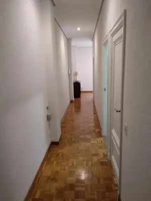 an empty hallway with a wooden floor and white walls at KM0 CENTRO CIUDAD in Valencia