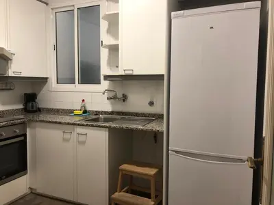 a kitchen with white cabinets and a refrigerator at KM0 CENTRO CIUDAD in Valencia