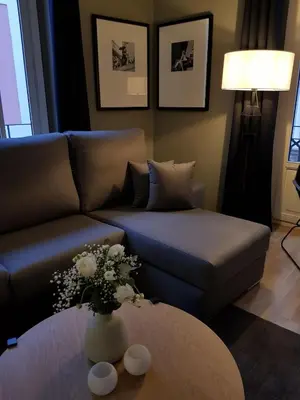 a living room with a couch and a table with flowers at BONNIES Suites & Spa Valencia in Valencia