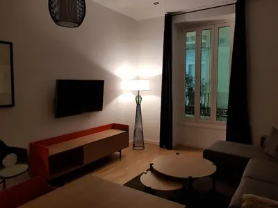 a living room with a couch and a table and a lamp at BONNIES Suites & Spa Valencia in Valencia