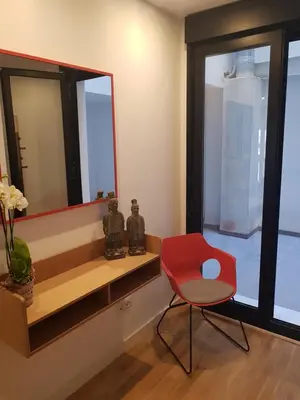 a red chair sitting in a room with a mirror at BONNIES Suites & Spa Valencia in Valencia