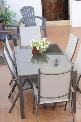 a white dining table and chairs with flowers on it at Casa La Posada de Chella in Chella