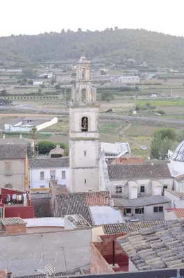 a tall building with a clock tower in a town at Casa La Posada de Chella in Chella