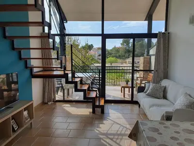 a living room with a spiral staircase in a house at Balcón de las Fuentes in Navarrés