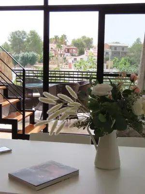 a vase with white flowers sitting on a table at Balcón de las Fuentes in Navarrés