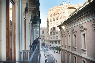 a man standing on a balcony of a building at Casa del Patriarca in Valencia