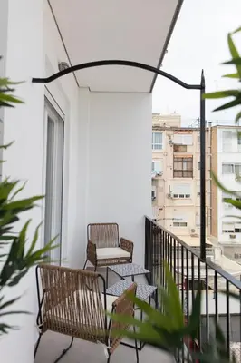 two chairs and a table on a balcony at FLORIT FLATS - Chic and Central in a lively but quiet area All walking distance in Valencia
