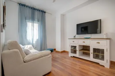 a white bedroom with a bed and a window at Beds & Breaks Glinka in Valencia