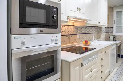 a kitchen with a microwave and a stove at My Loft 4 You Gran Via in Valencia
