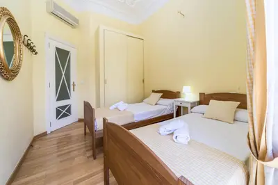 a bedroom with two beds and a mirror at My Loft 4 You Gran Via in Valencia