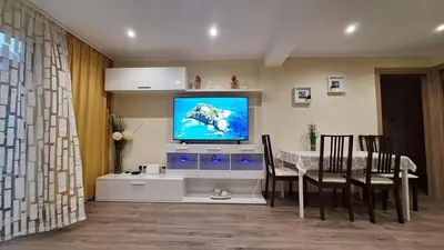 a living room with a dining table and a television at CasaMalva in Valencia