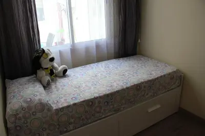 a teddy bear sitting on a bed in a bedroom at CasaMalva in Valencia