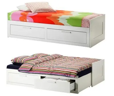 a bed with a white bed frame with a blanket on it at CasaMalva in Valencia