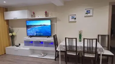 a dining room with a table and a flat screen tv at CasaMalva in Valencia