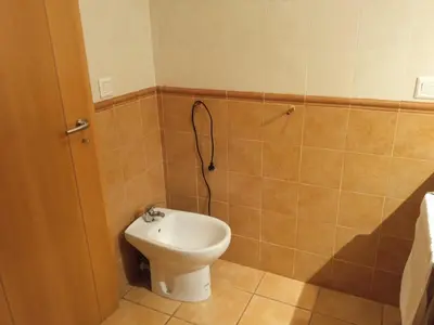 a bathroom with a toilet and a sink in it at Casa rural El Majuelo in Portera