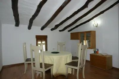 a dining room with a table and two chairs at Casa rural El Majuelo in Portera