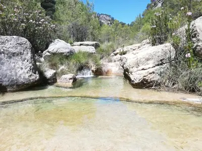 a pool of water with rocks in a creek at Casa rural El Majuelo in Portera