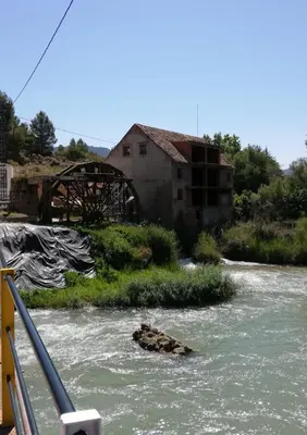 an old building in the middle of a river at Casa rural El Majuelo in Portera