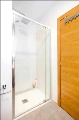 a shower with a glass door in a bathroom at Flats Burjasot in Valencia