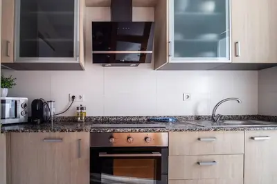 a kitchen with a sink and a stove top oven at Flats Burjasot in Valencia