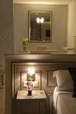 a bedroom with a bed and a table with a lamp at Hotel Luve in San Antonio de Banageber
