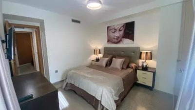 a bedroom with a bed and a painting on the wall at Avenida Mare Nostrum 7 Patacona Beach Breakfast items in the home in Valencia