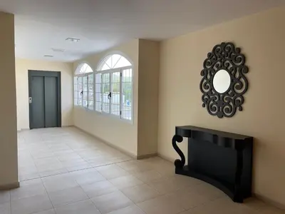 a hallway with a door and a mirror on the wall at Area de servicio El Rebollar in Requena