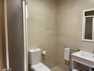 a bathroom with a toilet and a sink at Area de servicio El Rebollar in Requena