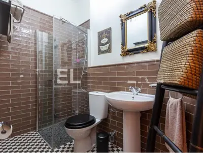 a bathroom with a toilet and a sink and a shower at La Isla del Júcar in Barraca de Aguas Vivas