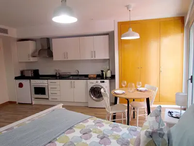 a room with a kitchen and a table with a dining room at Your Home at Valencia, El Carme in Valencia