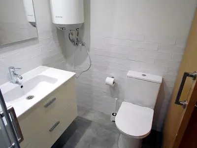 a bathroom with a white toilet and a sink at Your Home at Valencia, El Carme in Valencia
