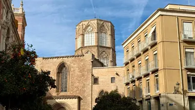 a building with a clock tower on top of it at Cosy Rooms Embajador in Valencia