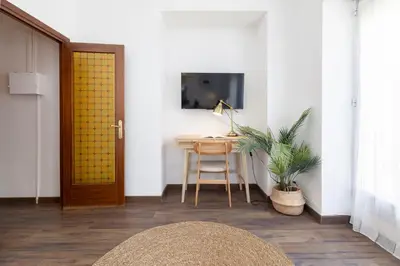 a room with a desk and a door and a table at Travel Habitat Cabanyal in Valencia