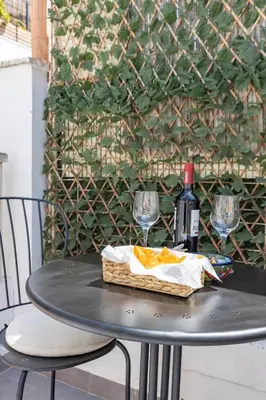 a table with two glasses and a bottle of wine at Travel Habitat Cabanyal in Valencia