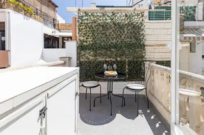 a small balcony with a table and chairs on a building at Travel Habitat Cabanyal in Valencia
