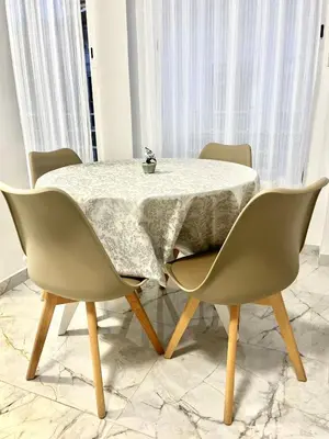 a table with four chairs and a table with a plant on it at Apartamento Luminoso cerca de la PLAYA y PUERTO in Valencia