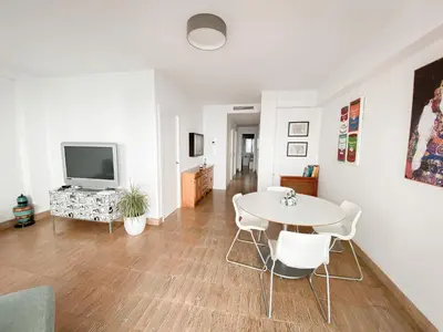 a living room with a table and a tv at Disfruta de unos días en la playa ¡Y mucho más! in Burriana