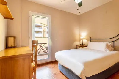 a bedroom with a bed and a window at Family-Friendly Beach House ideal for Holidays & Workers at Beach Sagunto Valencia in Sagunto